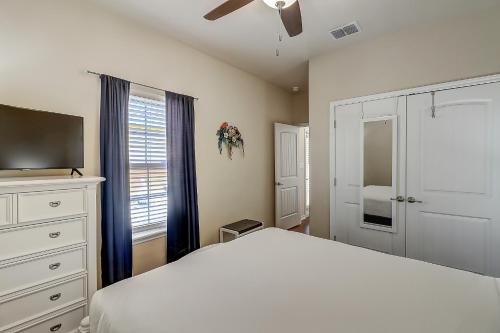 a bedroom with a bed and a tv and a window at Marquesas #310 in Padre Island