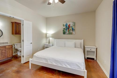 a bedroom with a white bed and a bathroom at Marquesas #310 in Padre Island