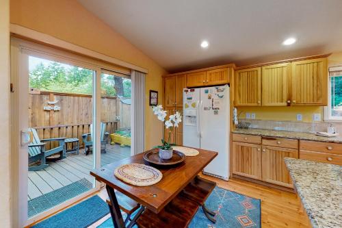 a kitchen with a table and a refrigerator at Gray Whale Cove MCA 935 in Manzanita