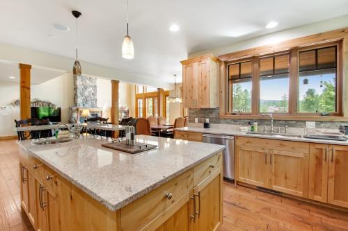 a large kitchen with wooden cabinets and a large island at Cascade Serenade at Suncadia Resort in Cle Elum