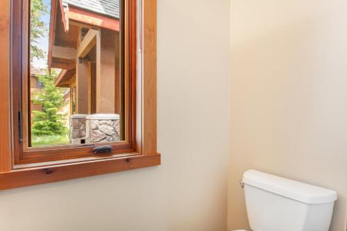 a bathroom with a toilet and a window at Cascade Serenade at Suncadia Resort in Cle Elum