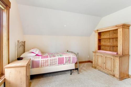 a bedroom with a bed and a wooden cabinet at Cascade Serenade at Suncadia Resort in Cle Elum