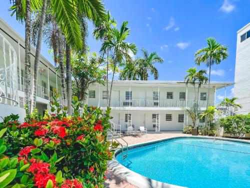 an exterior view of a house with a swimming pool and palm trees at Winterset in Fort Lauderdale