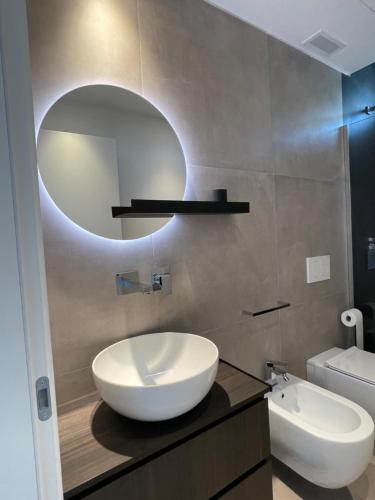a bathroom with a white sink and a mirror at La Torre del Porto in Riccione