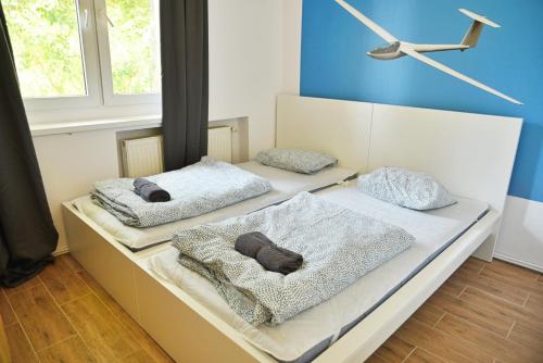 two beds with pillows on them in a room at Apartamenty Lotnisko Leszno in Leszno