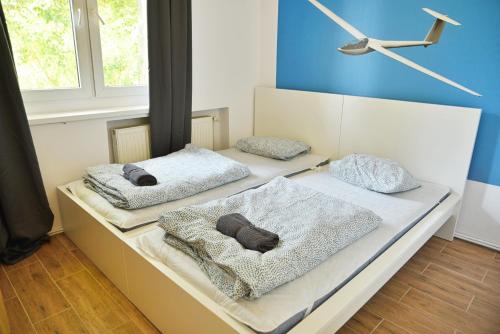 two beds with pillows on them in a room at Apartamenty Lotnisko Leszno in Leszno