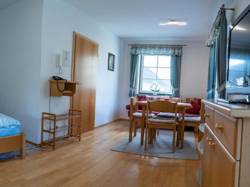 a kitchen and dining room with a table and chairs at Appartementhof Stadler in Pocking