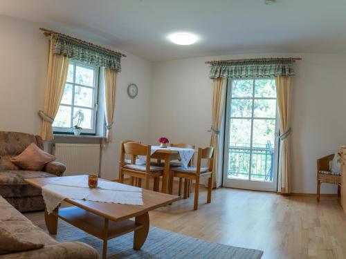 a living room with a couch and a table at Appartementhof Stadler in Pocking