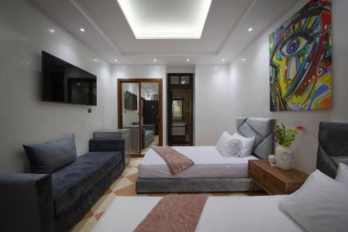 een woonkamer met een bed en een bank bij RIAD DOUIRTNA in Marrakesh