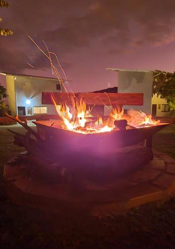 a fire pit in the middle of a yard at night at NATIVOS DE MINAS in Santana do Riacho