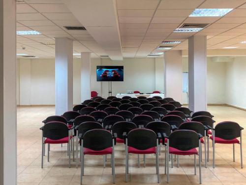 a room filled with chairs and a projection screen at Sol Marbella Estepona Atalaya Park in Estepona