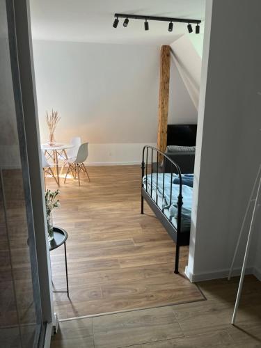 a living room with a bed and a table at Apartament Willa Bellevue in Rabka-Zdrój