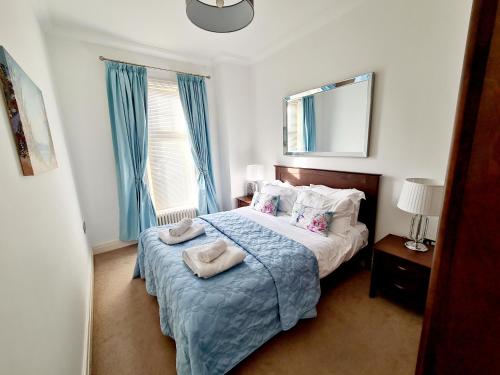 a bedroom with a bed with two towels on it at Vitamin Sea Beachfront Apartment Ramsgate - Sleeps 4 in Ramsgate