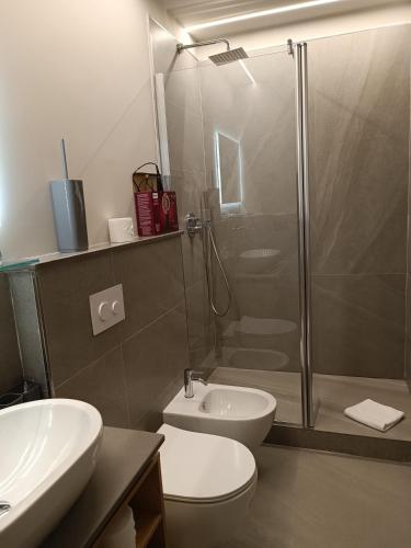 a bathroom with a shower and a toilet and a sink at Le dimore di Megollo - Free Parking in Genova