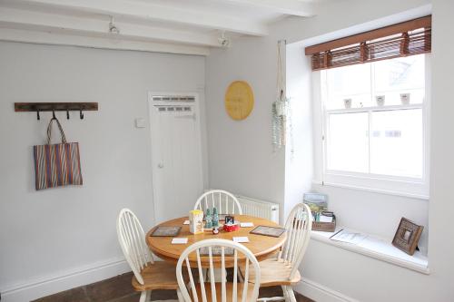 a dining room with a wooden table and chairs at Millgate Cottage in the heart of Richmond in Richmond