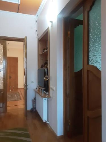 a hallway with a room with a door and a television at Colchis ca777 in Kutaisi