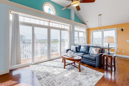 a living room with a couch and a table at Hampton Beach Beauty in Hampton