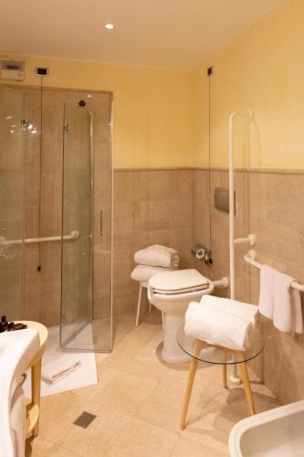 a bathroom with a shower and a toilet and a sink at Grand Hotel Royal E Golf in Courmayeur