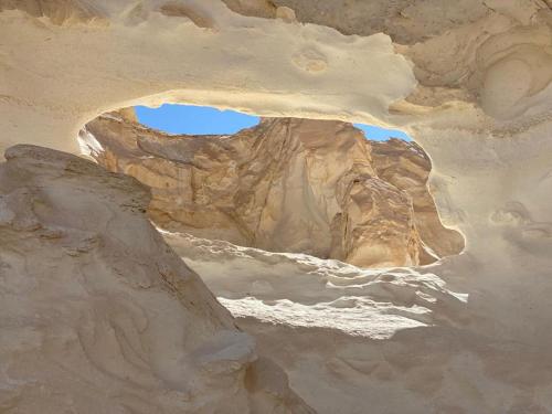 a view of a cave in a rock formation at Rahala Safari Hotel in Qasr Al Farafirah