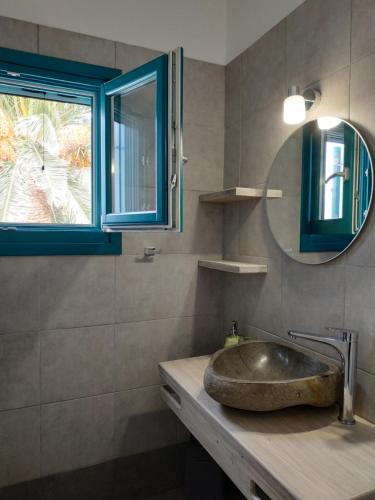 a bathroom with a sink and a mirror at ANCIENT MEROPIA, Apollonia in Apollonia