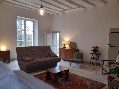 a living room with a couch and a table at Château de Charnizay in Charnizay