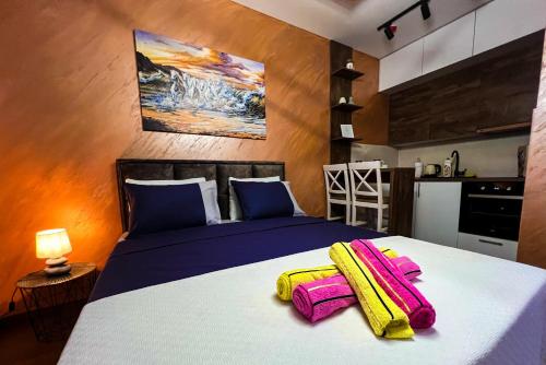 a bedroom with a bed with two towels on it at Green Hills by Rent a car MI in Podgorica