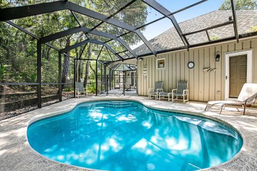 a swimming pool in a house with a pergola at 13 Green Winged Teal in Fernandina Beach