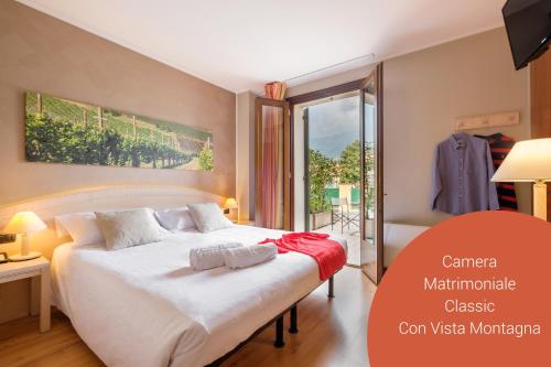 a bedroom with a large white bed in a room at Wine Hotel San Giacomo Activity & Wellness in Paderno del Grappa