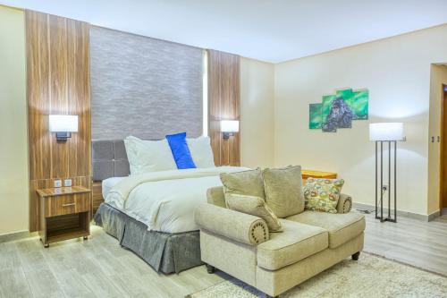 a hotel room with a bed and a couch at Virunga Inn Resort & Spa in Kinigi