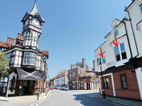 a city street with a clock tower on a building at The Clock Tower Apartment - Spacious, Modern, 2 Bedroom Apartment , Southsea with Free parking - sleeps 4 in Portsmouth