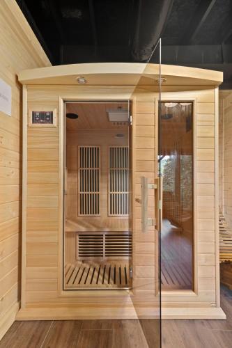 a large wooden sauna with a glass door at Smokies Overlook Lodge in Waynesville