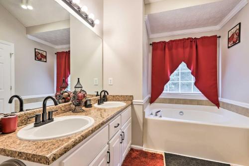 a bathroom with two sinks and a tub and a large mirror at Covington Abode Less Than 30 Mi to Stone Mtn Park! in Covington