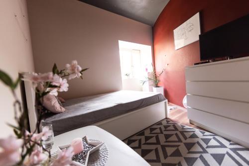 a small bedroom with a bed and a window at Rooms Viktorin in Ptuj