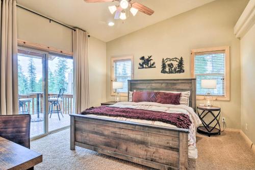 a bedroom with a large bed and a balcony at All-Encompassing Cabin with Fire Pit and Kayaks! in Duck Creek Village