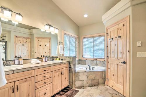 a large bathroom with two sinks and a tub at All-Encompassing Cabin with Fire Pit and Kayaks! in Duck Creek Village