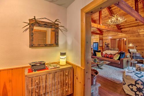 a room with a mirror and a living room at 1 Mi to Rainbow Lake Lakeside Cabin with Deck! in Lake of the Woods