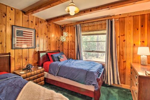 a bedroom with a bed and a window at 1 Mi to Rainbow Lake Lakeside Cabin with Deck! in Lake of the Woods