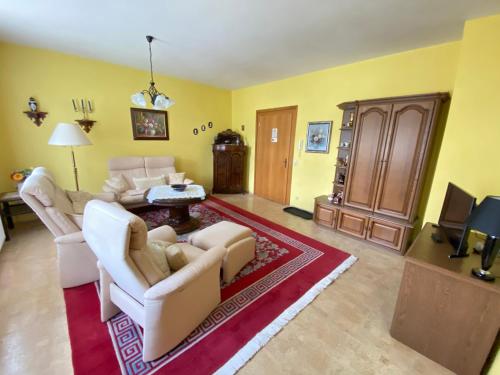 a living room with two couches and a tv at Villa Borchert in Wernigerode
