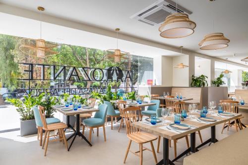 a restaurant with tables and chairs and a large window at Occidental Puerto Banús in Marbella