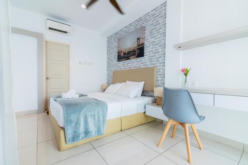 a bedroom with a bed and a blue chair at Mansion One 4Ever Home by Wealth Lifestyle in George Town