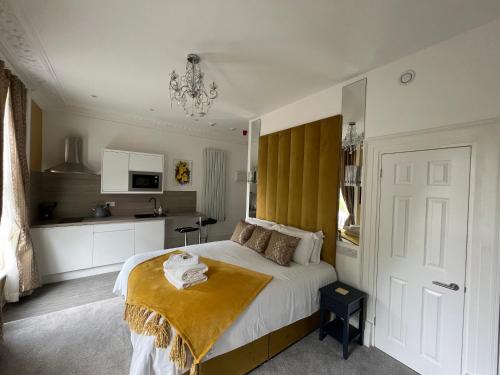 a bedroom with a bed and a kitchen at Winckley Square Residences in Preston