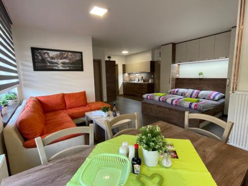 a living room with a couch and a table at Apartment WELLNESS Vlčková in Vlčková