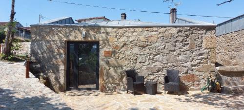 a stone building with a door in the side of it at Green Paradise Glamping in Covas