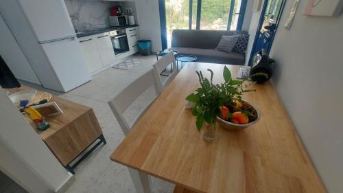 a living room with a table with a bowl of fruit at Villa Edna Crete in Agios Nikolaos