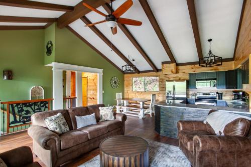 a living room with two couches and a kitchen at Serenity View- FirePit, Game Room, Community Pools in Gatlinburg