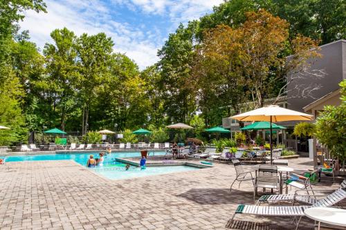 a swimming pool with people playing in it at Serenity View- FirePit, Game Room, Community Pools in Gatlinburg
