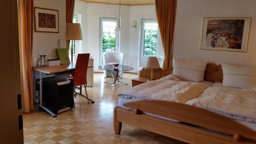 Ayl的住宿－Weingut Raevenhof，一间卧室配有一张床、一张桌子和一张桌子