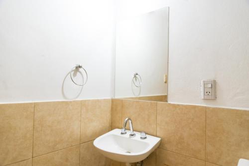 a bathroom with a sink and a mirror at Alojamiento Aloja N1 in Mendoza