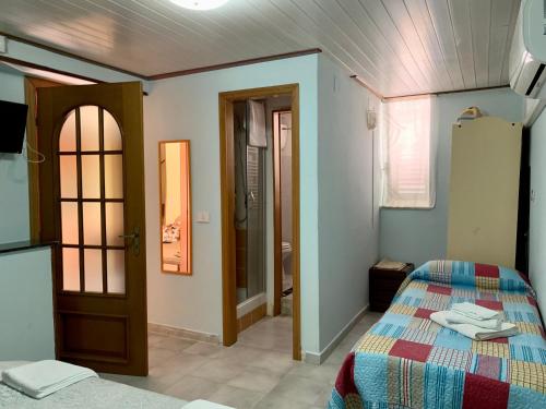 a bedroom with a bed and a door and a room at La Casa di Gabry 2 in Valledolmo
