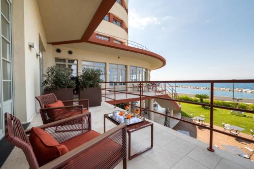 a balcony with chairs and a view of the ocean at Grand Hotel Torre Fara in Chiavari